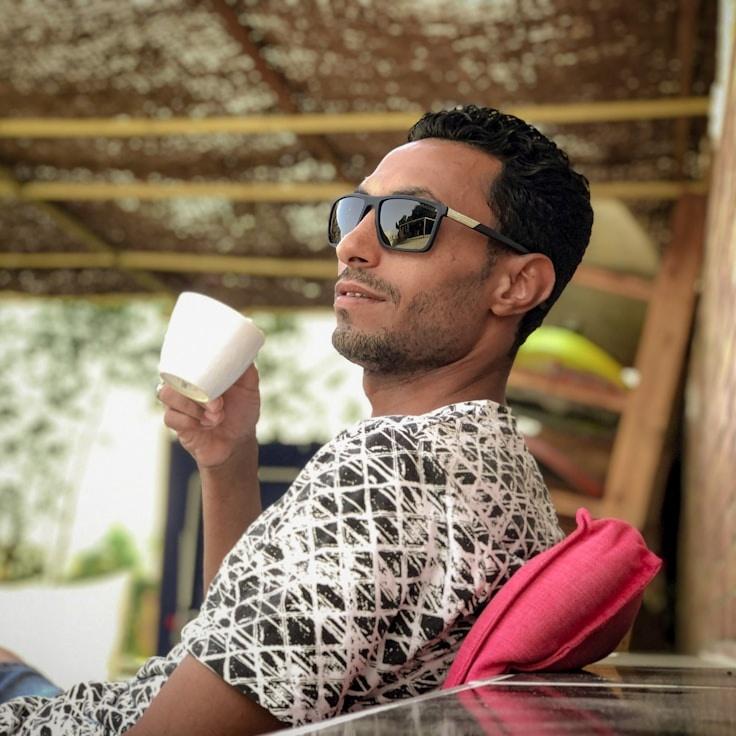 Alex Rivera, Lead Design Curator at RiverBrookStone, reviewing corporate floral arrangements